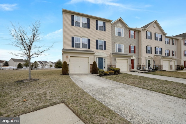 multi unit property featuring a front lawn, stone siding, a residential view, concrete driveway, and an attached garage