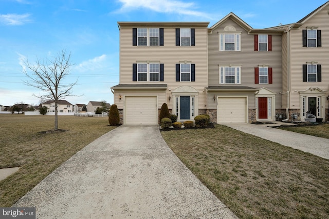 view of property with stone siding, a front lawn, an attached garage, and driveway