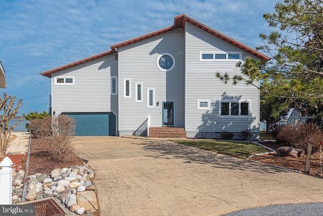 view of property exterior featuring a garage and driveway