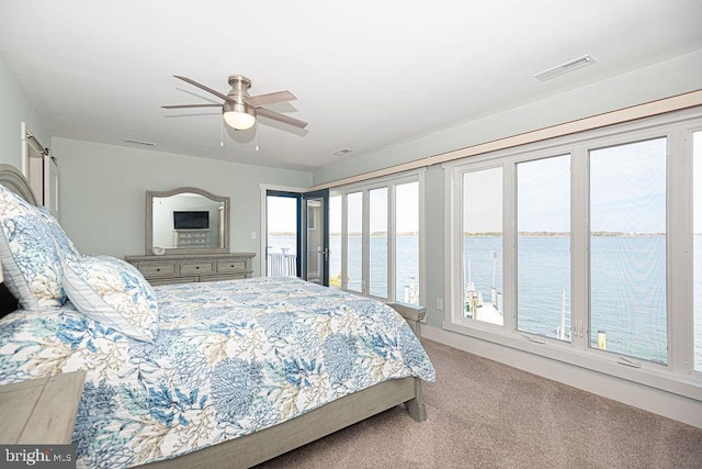 bedroom with access to exterior, a ceiling fan, visible vents, and carpet flooring