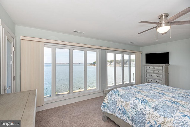 carpeted bedroom with ceiling fan and visible vents