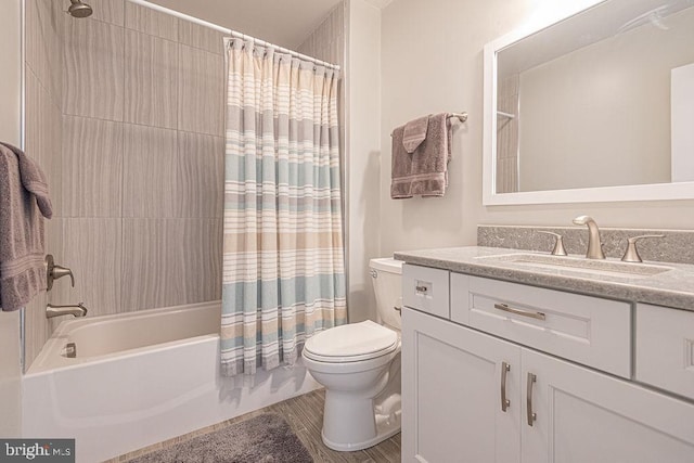 full bathroom with toilet, shower / tub combo, and vanity