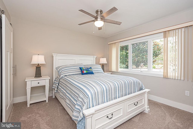 bedroom with ceiling fan, baseboards, and light colored carpet