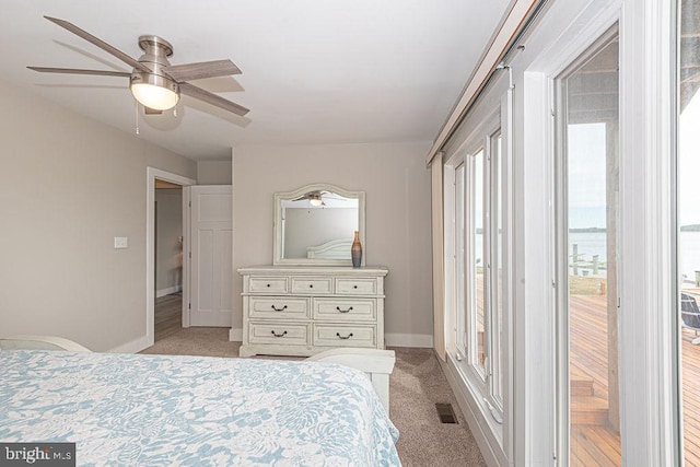 bedroom with visible vents, baseboards, light colored carpet, ceiling fan, and access to outside