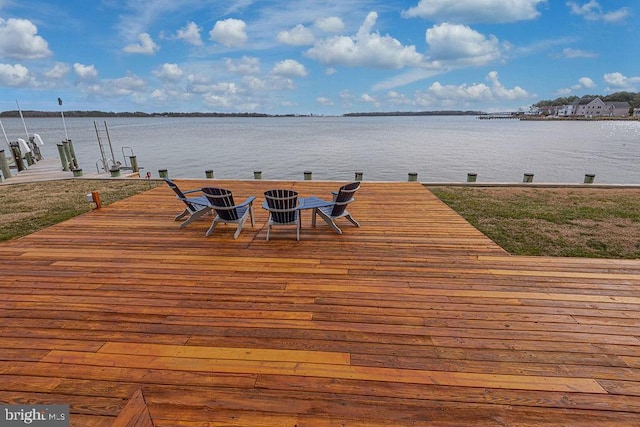 view of dock featuring a water view and a fire pit