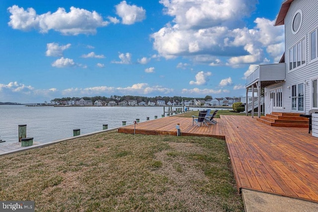 view of yard with a deck with water view