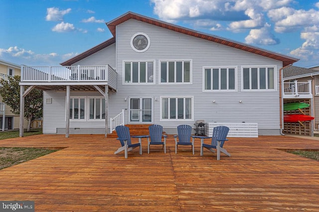 rear view of property featuring crawl space and a deck