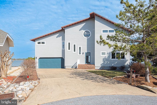 view of front of house with an attached garage and concrete driveway