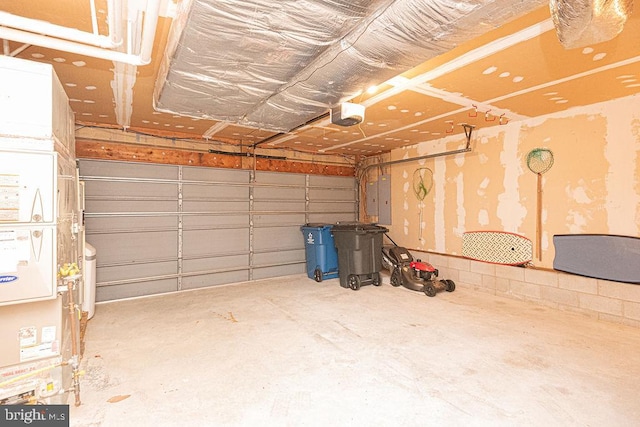 garage featuring electric panel and a garage door opener