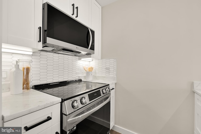 kitchen featuring appliances with stainless steel finishes, backsplash, and white cabinetry