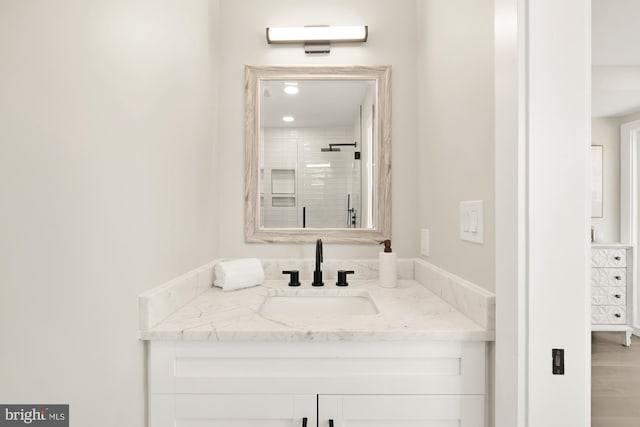 bathroom with a stall shower and vanity