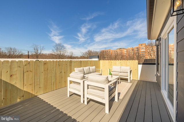 wooden terrace with an outdoor living space