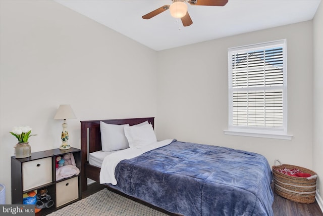 bedroom featuring multiple windows, a ceiling fan, and wood finished floors