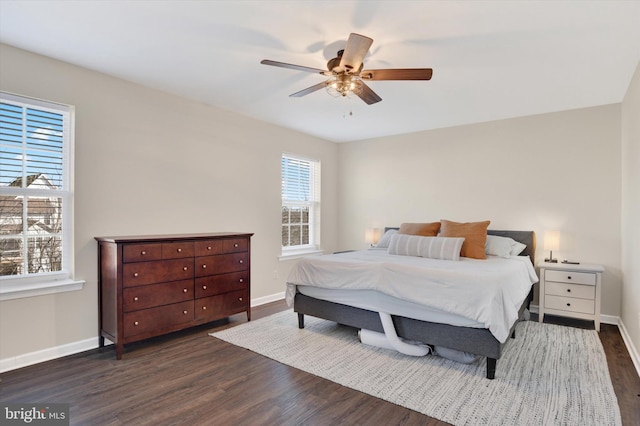 bedroom with a ceiling fan, baseboards, and dark wood-style flooring