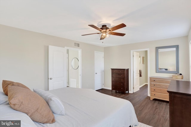 bedroom with ceiling fan, visible vents, baseboards, and dark wood-style floors