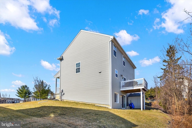 view of property exterior with a wooden deck and a lawn