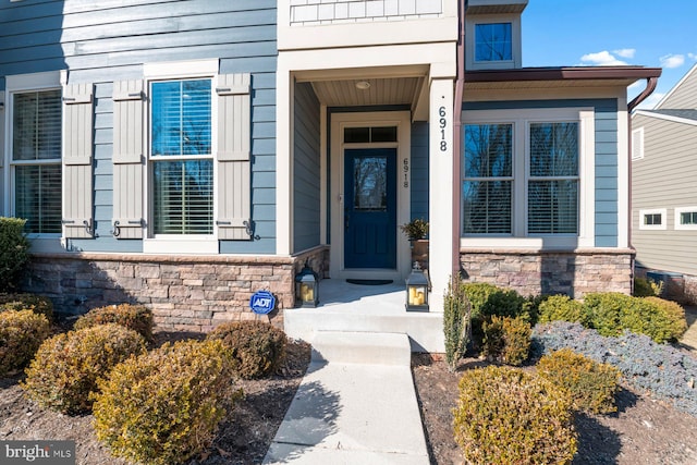 view of exterior entry with stone siding