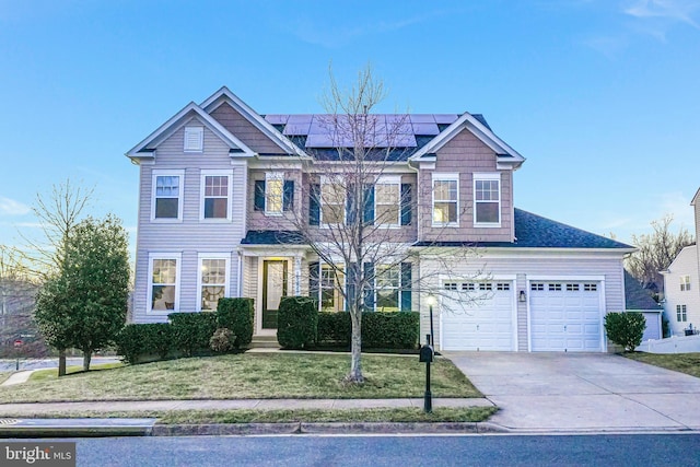 view of front of house with driveway, a garage, roof mounted solar panels, and a front lawn