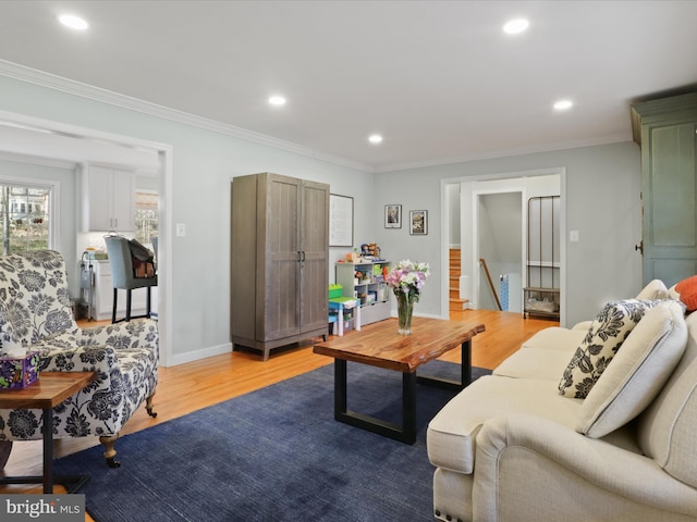 living area with crown molding, baseboards, stairway, recessed lighting, and wood finished floors