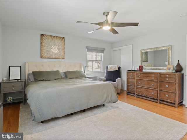 bedroom featuring a closet, wood finished floors, and a ceiling fan