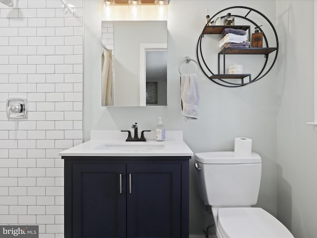 bathroom with a shower with shower curtain, toilet, and vanity