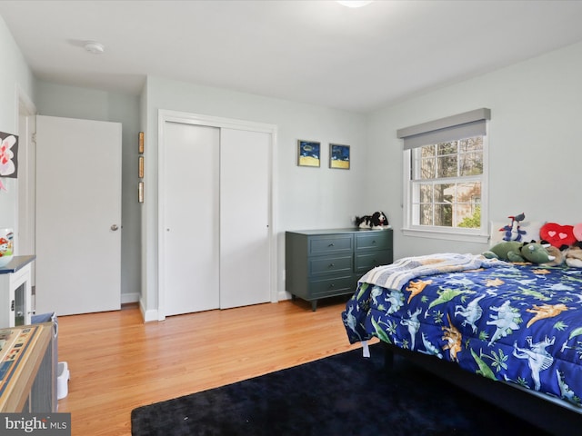 bedroom featuring a closet and light wood-style floors