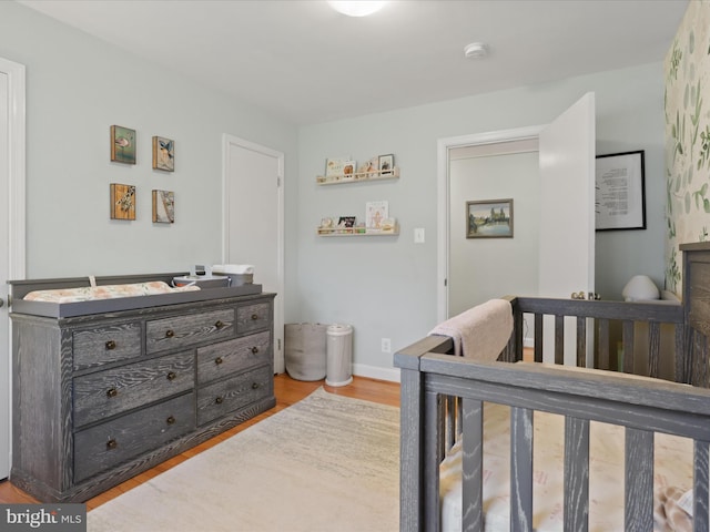 bedroom featuring baseboards and wood finished floors