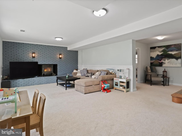 carpeted living room featuring a wood stove and visible vents