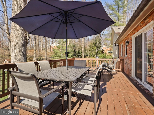 wooden terrace with outdoor dining space