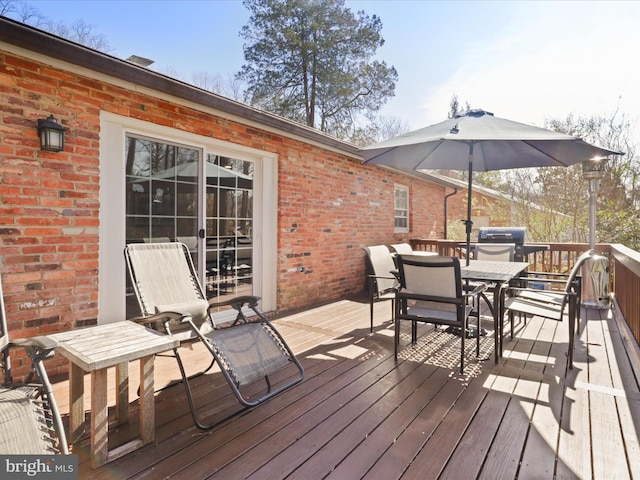 wooden terrace with outdoor dining space