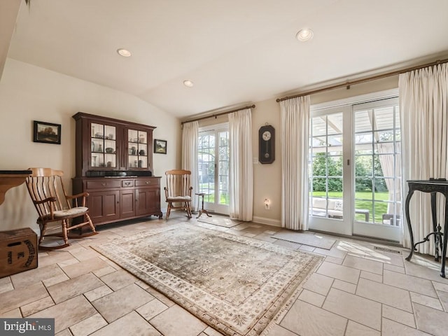 entryway with lofted ceiling, baseboards, and recessed lighting