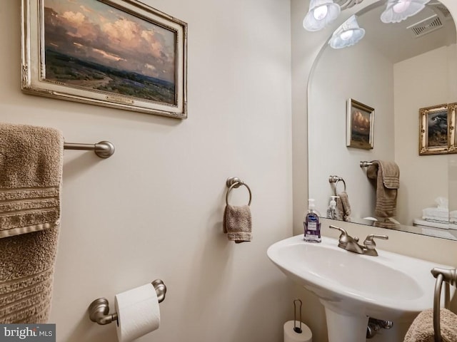 bathroom featuring visible vents and a sink