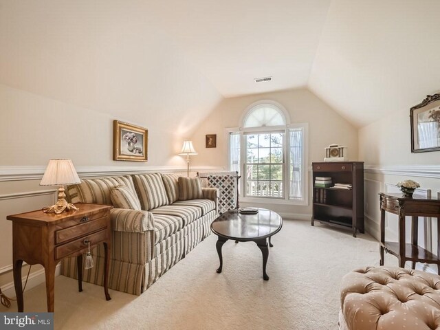 carpeted living room featuring lofted ceiling and visible vents