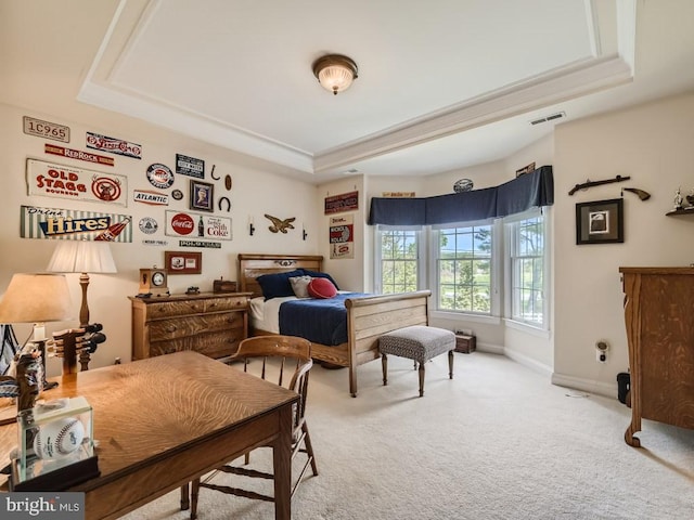 bedroom with a tray ceiling, carpet flooring, visible vents, and baseboards