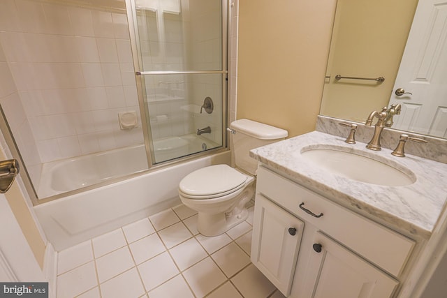 bathroom with bath / shower combo with glass door, vanity, toilet, and tile patterned floors