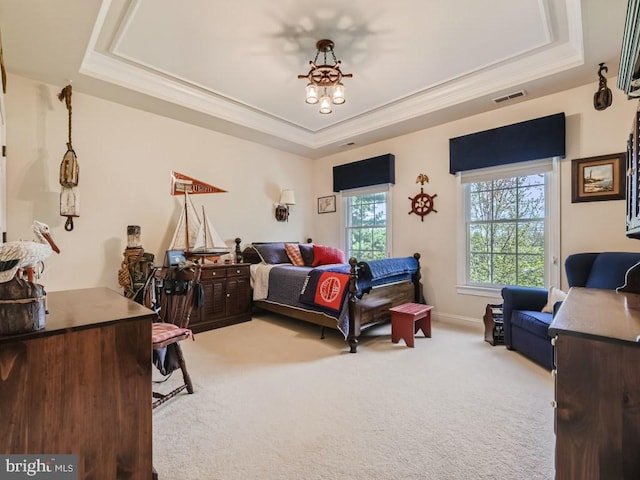 carpeted bedroom featuring ornamental molding, a raised ceiling, visible vents, and baseboards