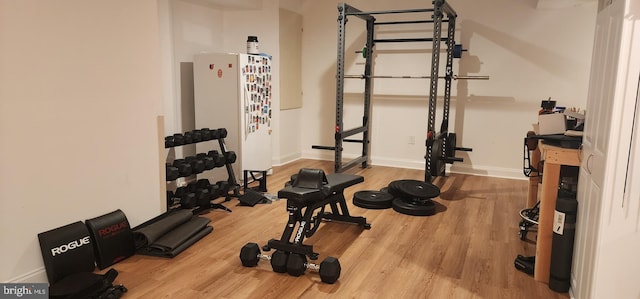 workout area with wood finished floors and baseboards