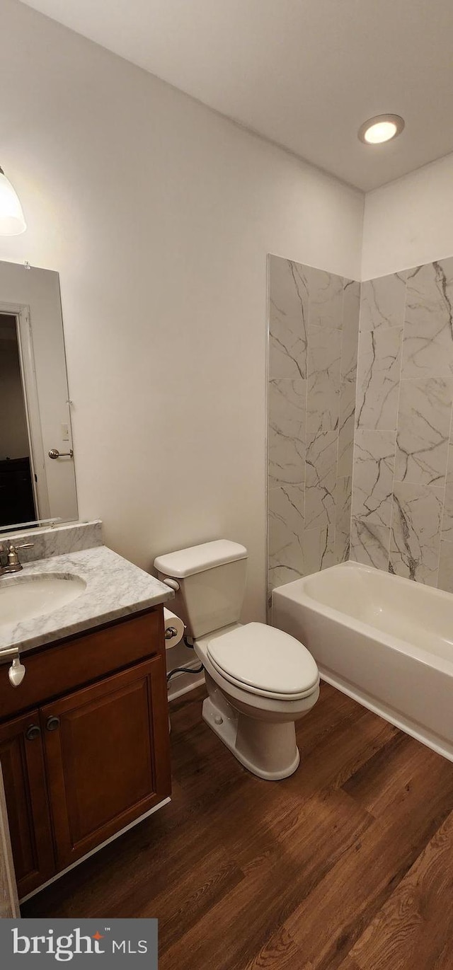 full bathroom with vanity, wood finished floors, and toilet