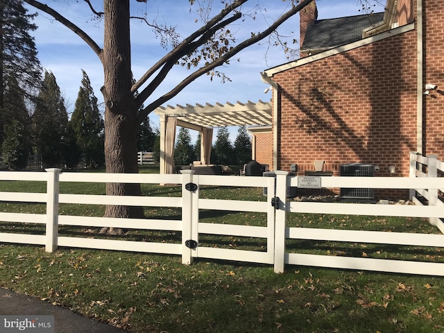 view of side of home with brick siding, fence, and a pergola