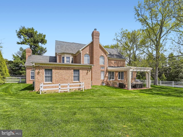 back of property with brick siding, a lawn, a chimney, and a pergola