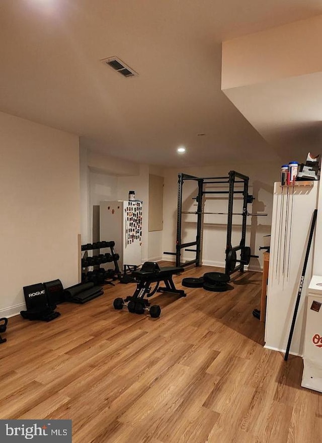 exercise room featuring visible vents and wood finished floors