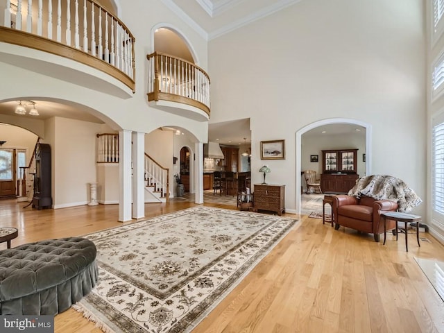 entryway featuring stairs, ornamental molding, wood finished floors, and baseboards