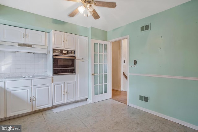 kitchen featuring visible vents, under cabinet range hood, black appliances, and white cabinetry