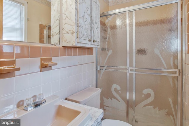 full bathroom with tile walls, a shower stall, toilet, and vanity