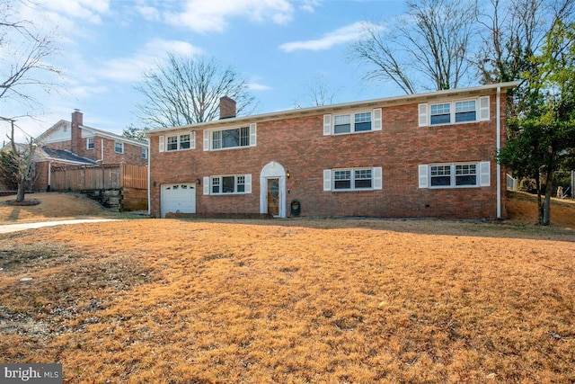 view of front of home featuring an attached garage, a chimney, fence, and brick siding