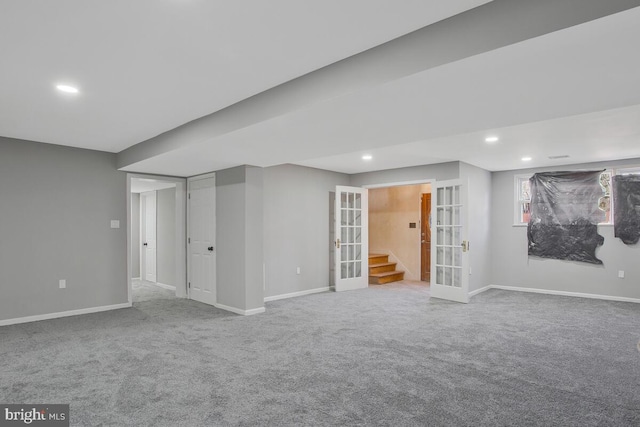 basement featuring recessed lighting, baseboards, and french doors