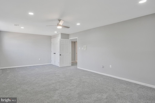 spare room featuring ceiling fan, recessed lighting, carpet, and baseboards