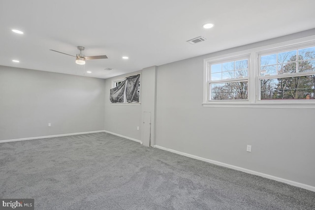 empty room featuring carpet, visible vents, and recessed lighting