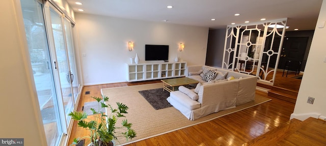 living area with recessed lighting, visible vents, and wood finished floors