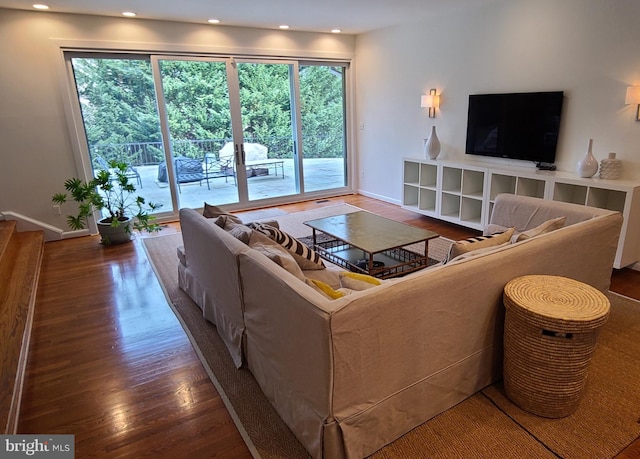 living room featuring baseboards, wood finished floors, and recessed lighting